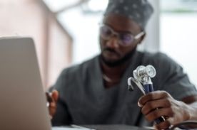 medical worker with laptop and stethoscope.