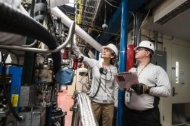 training apprentice in manufacturing facility.