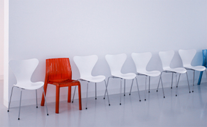 White and red chairs in a line.