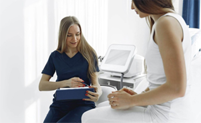 Medical assistant with patient.