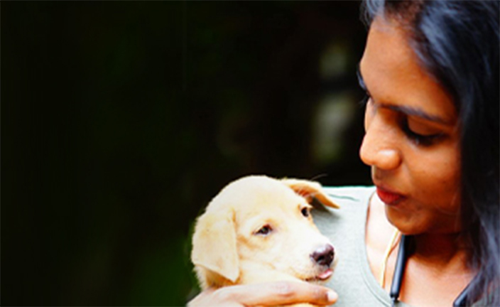 Woman holding puppy.