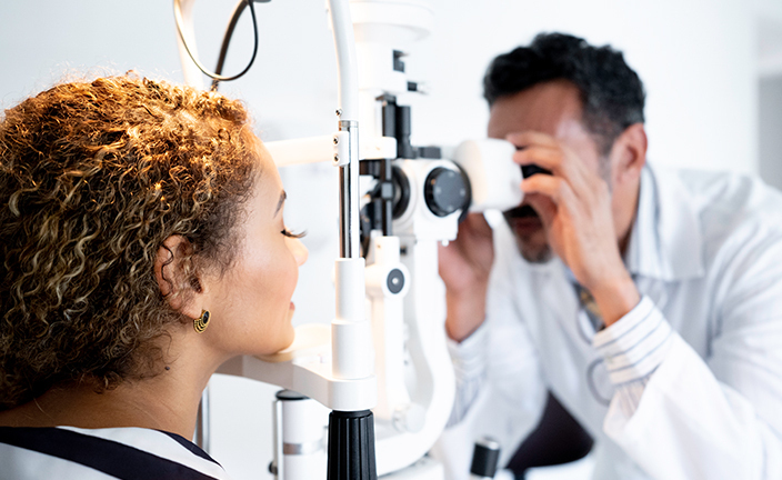 An optician performing an eye exam.
