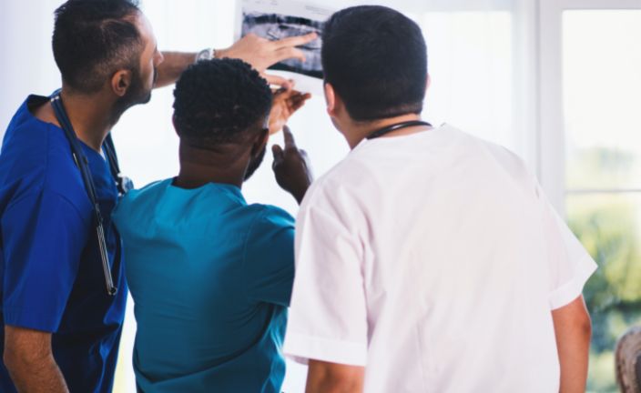 group of healthcare workers reviewing x-ray.