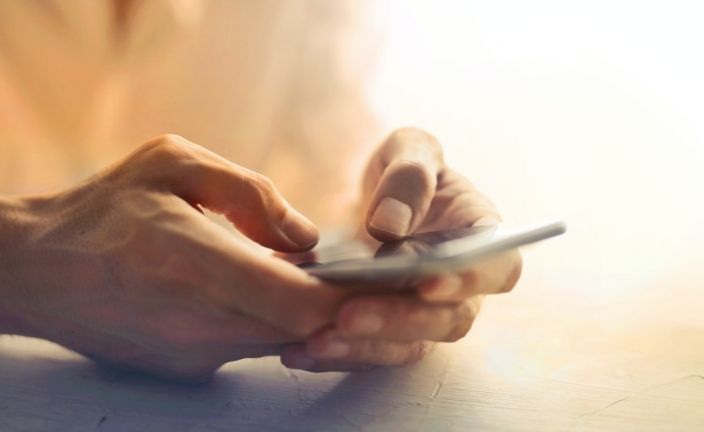 hands holding smartphone.