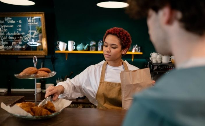 Barista serving customer.