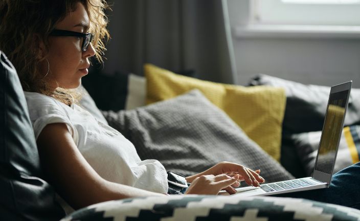 women at home using laptop.