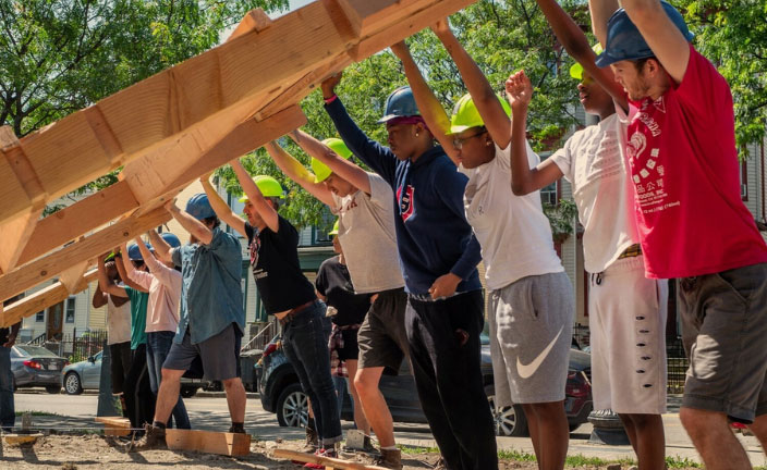 YouthBuild Boston learners helping construct a building.