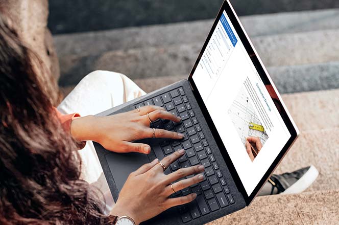 Woman using a laptop outside.