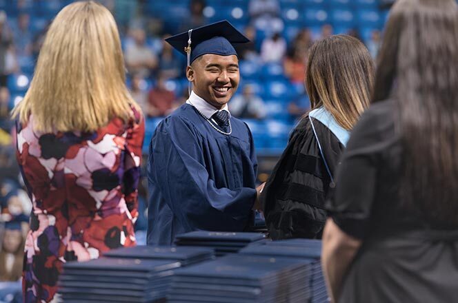 Penn Foster Graduate receiving their diploma.