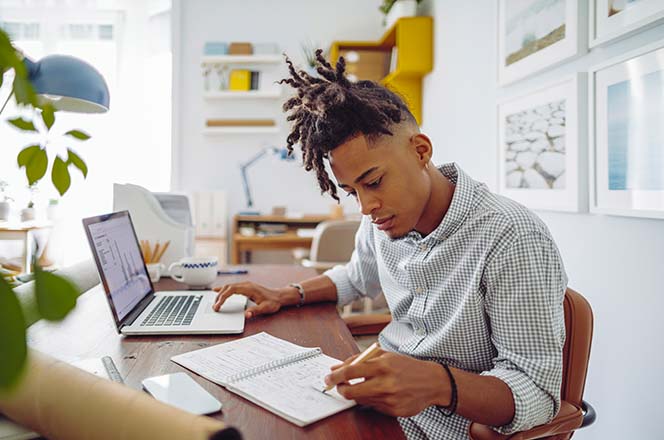 Man studying and taking notes.