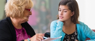 Teacher offering help to a student.