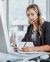 administrative assistant talks on headset.