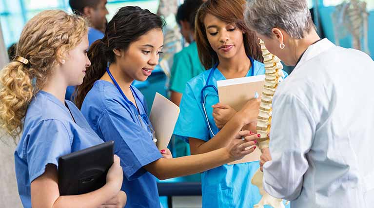 medical students and teacher in a lab.