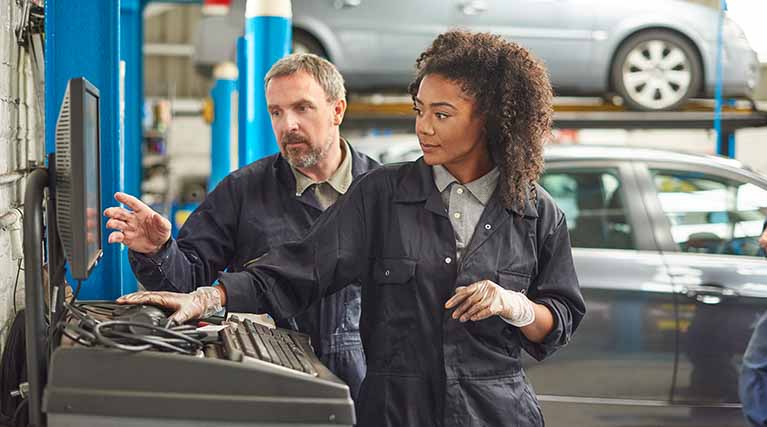 automotive technician working using a computer