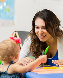 early childhood educator playing with student.