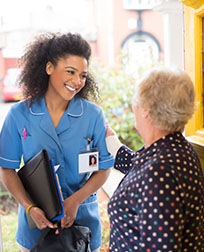 patient greets home nurse at front door