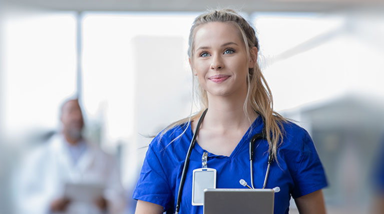 medical assistant wearing scrubs and stethoscope.