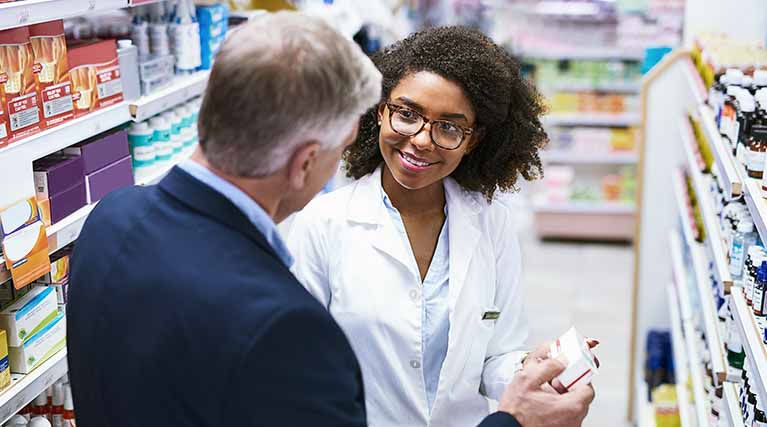 pharmacy employee assisting a customer.