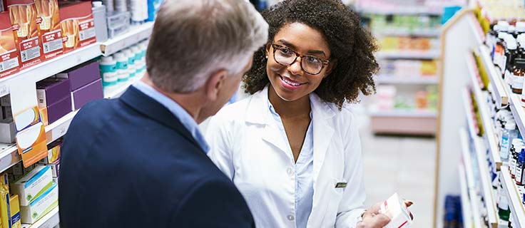 pharmacy employee assisting a customer.