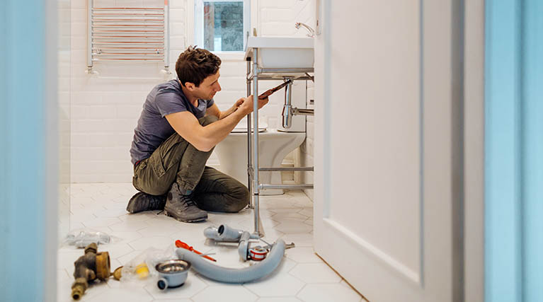 plumber fixing bathroom sink drain