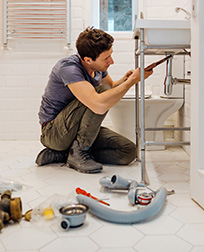 plumber fixing bathroom sink drain