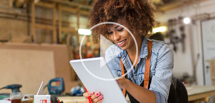 Woman learning carpentry online using a personal tablet.