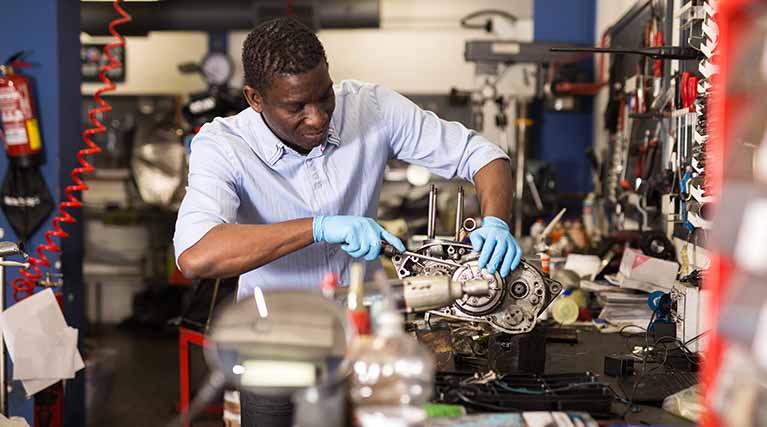 mechanic working on a small engine.